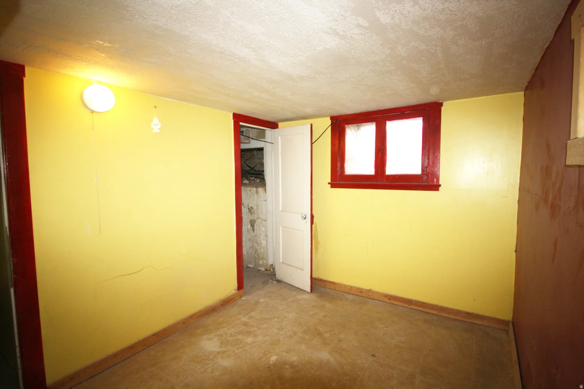 Basement Bedroom 5 featuring a textured ceiling and baseboards
