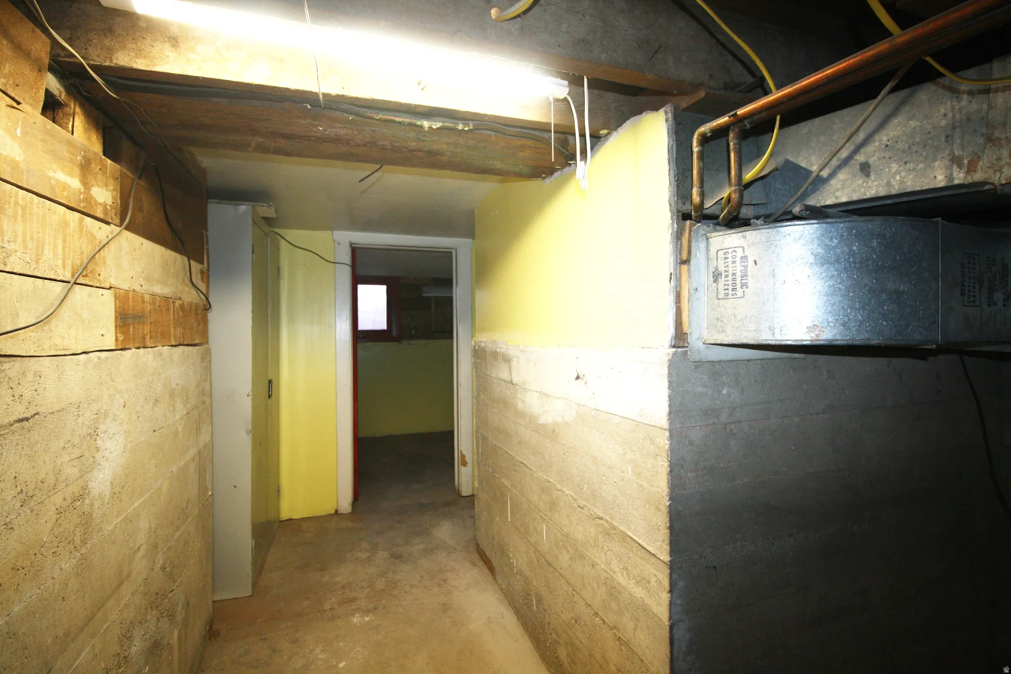 Hallway featuring concrete flooring
