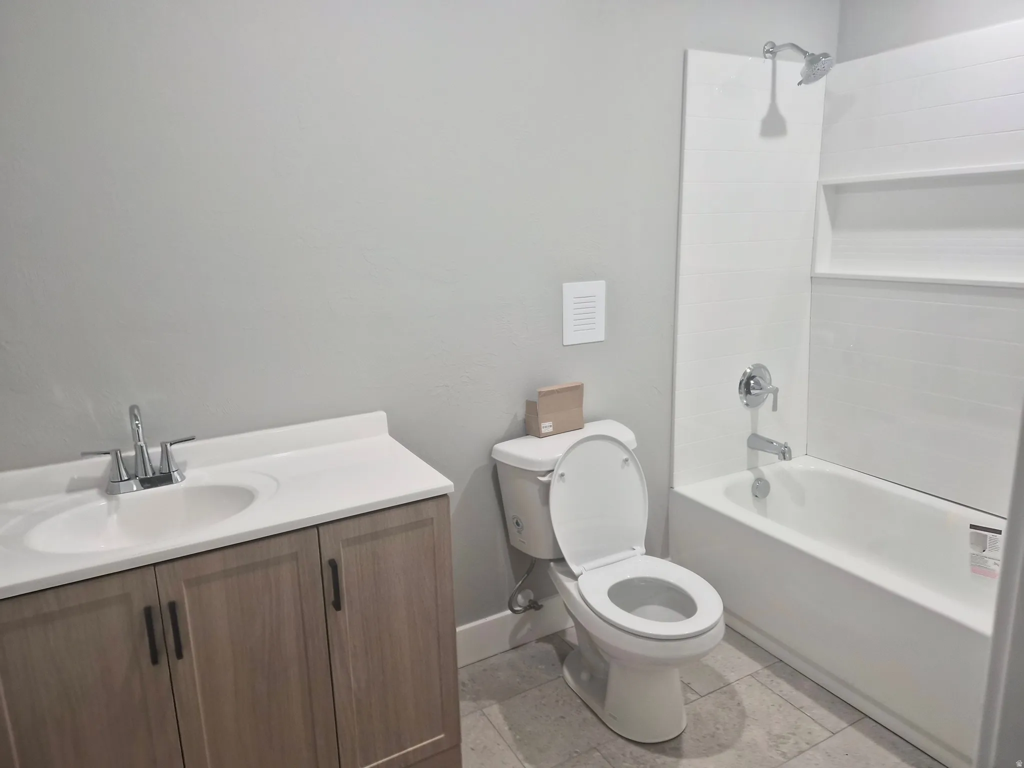 Bathroom featuring vanity and shower / tub combination