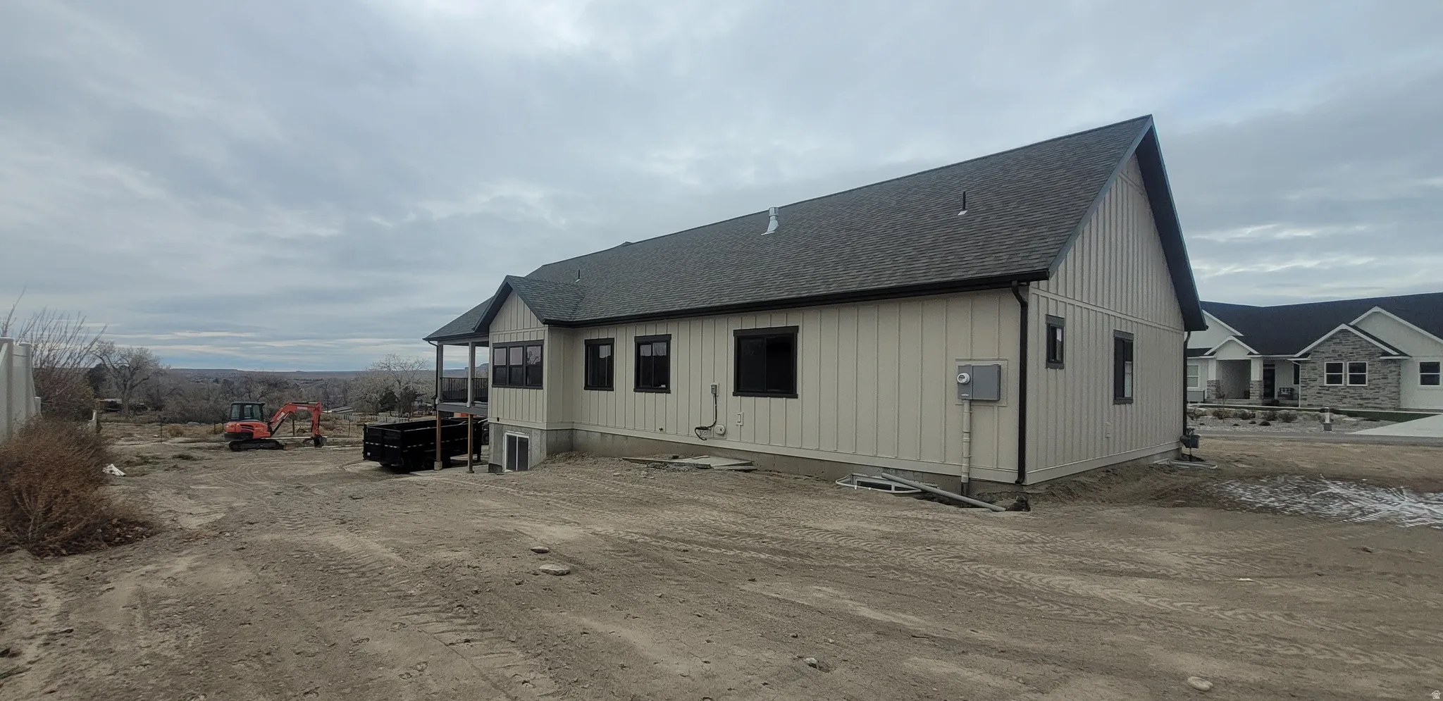 Rear view of property with roof with shingles and a sunroom