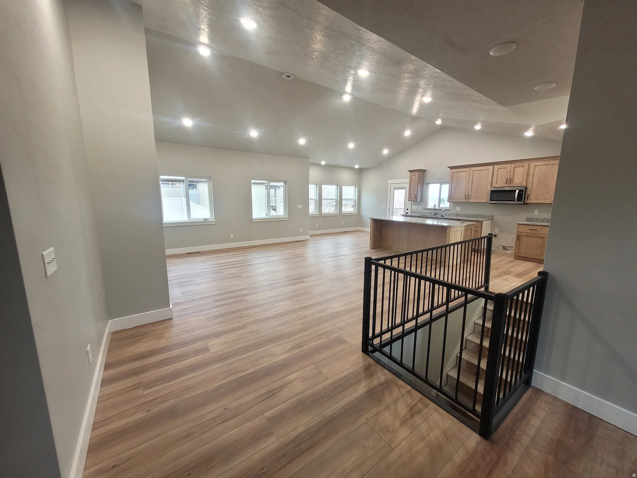 Stairway with wood finished floors and recessed lighting