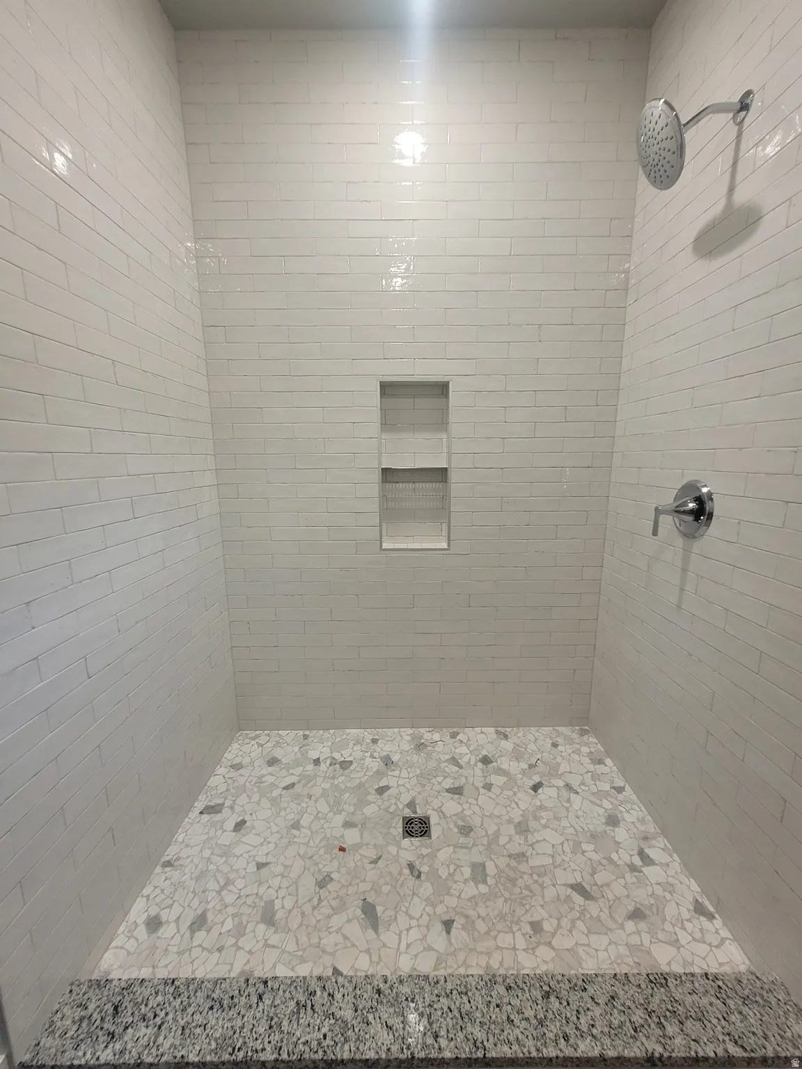 Full bathroom with a tile shower