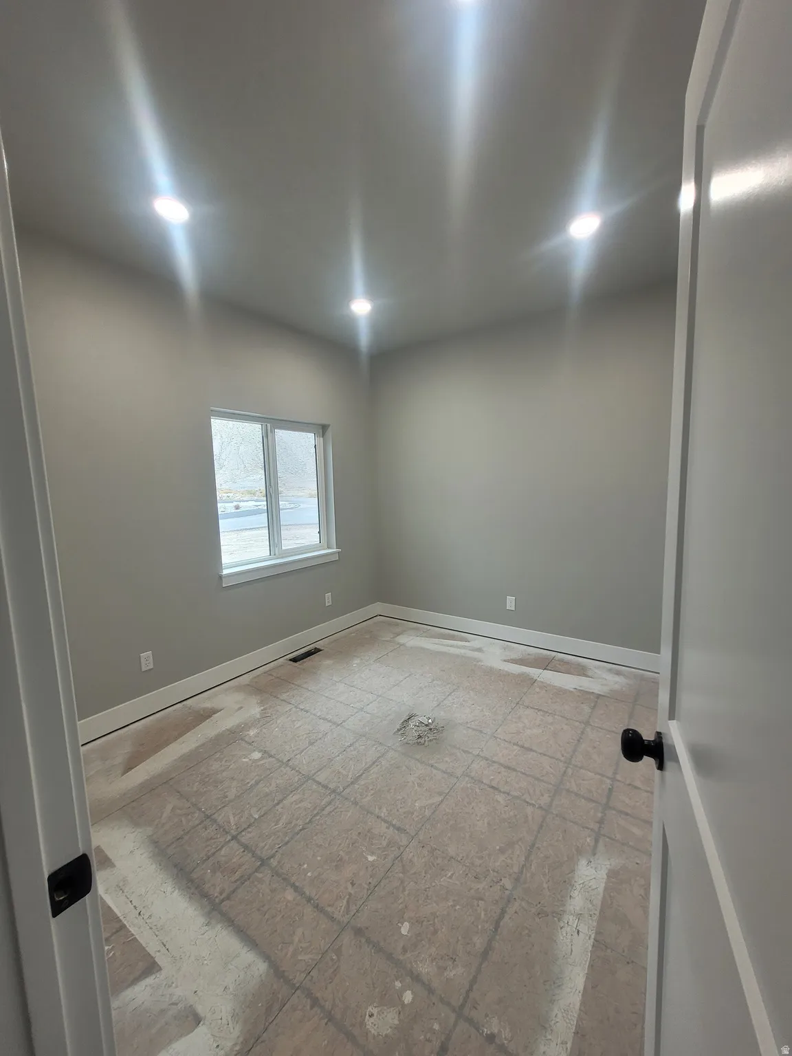 Unfurnished room with baseboards