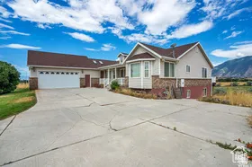 Ranch-style home with driveway, a garage, and a porch