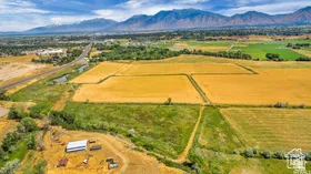 Aerial view of sparsely populated area with mountains and abundant farmland