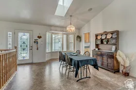 Dining room with lofted ceiling and a skylight