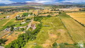 Aerial view of property's location with rural landscape and a mountainous background