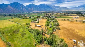 View of rural area featuring extensive farmland and a mountain backdrop
