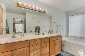 Full bathroom with double vanity and a garden tub