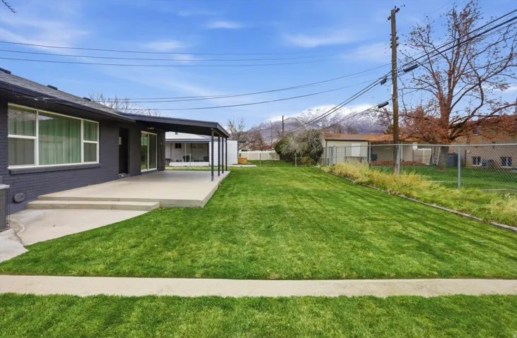 Fenced backyard with a patio