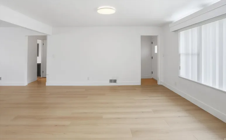 Empty room featuring light wood-style flooring