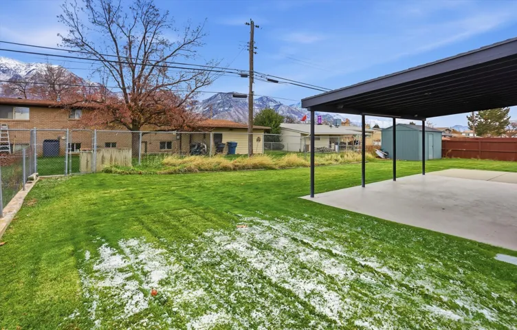 Fenced backyard with a mountain view and a storage unit