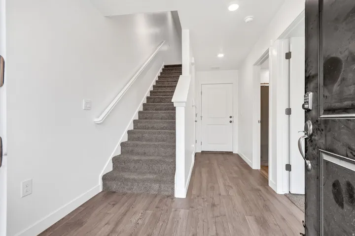 Foyer entrance featuring light wood-type flooring, stairway, and recessed lighting