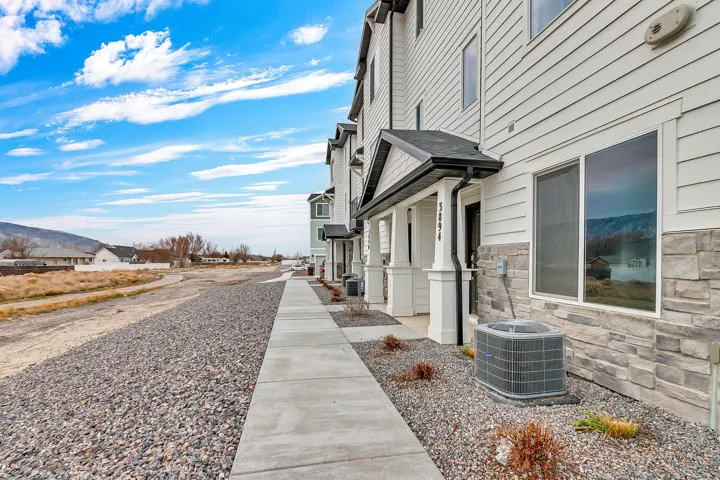 View of property exterior featuring stone siding and a residential view
