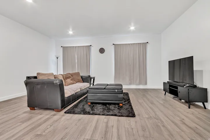 Living area with light wood-type flooring and baseboards