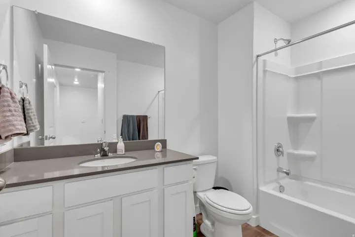 Full bath featuring vanity and bathing tub / shower combination