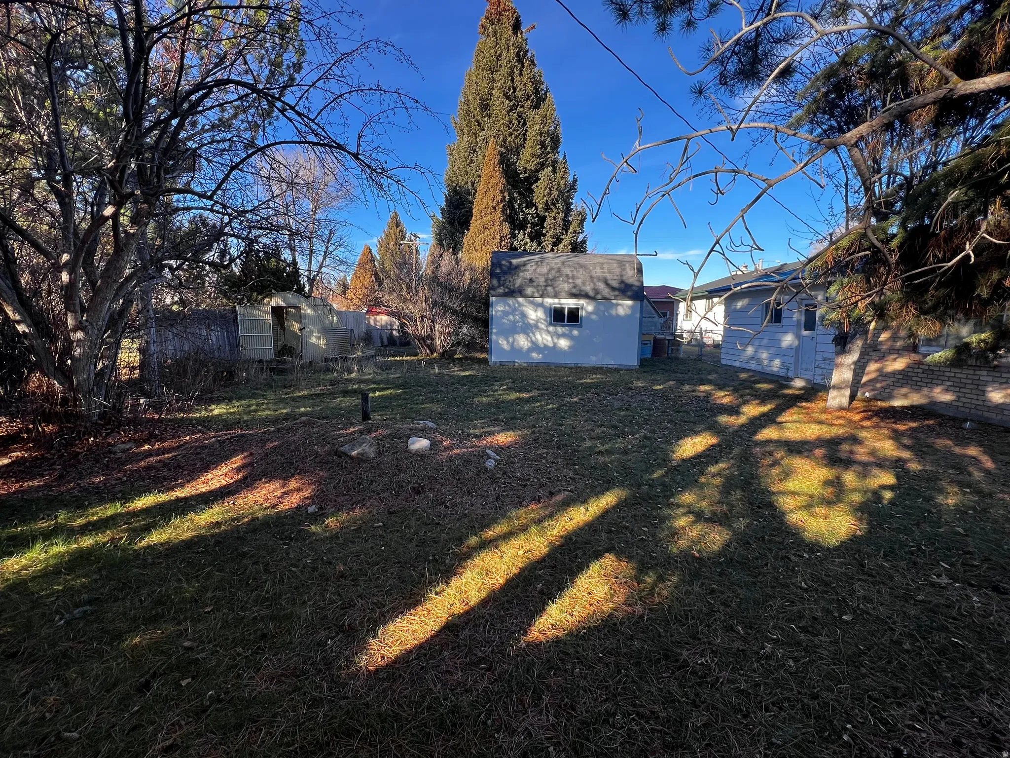 View of yard with a storage unit