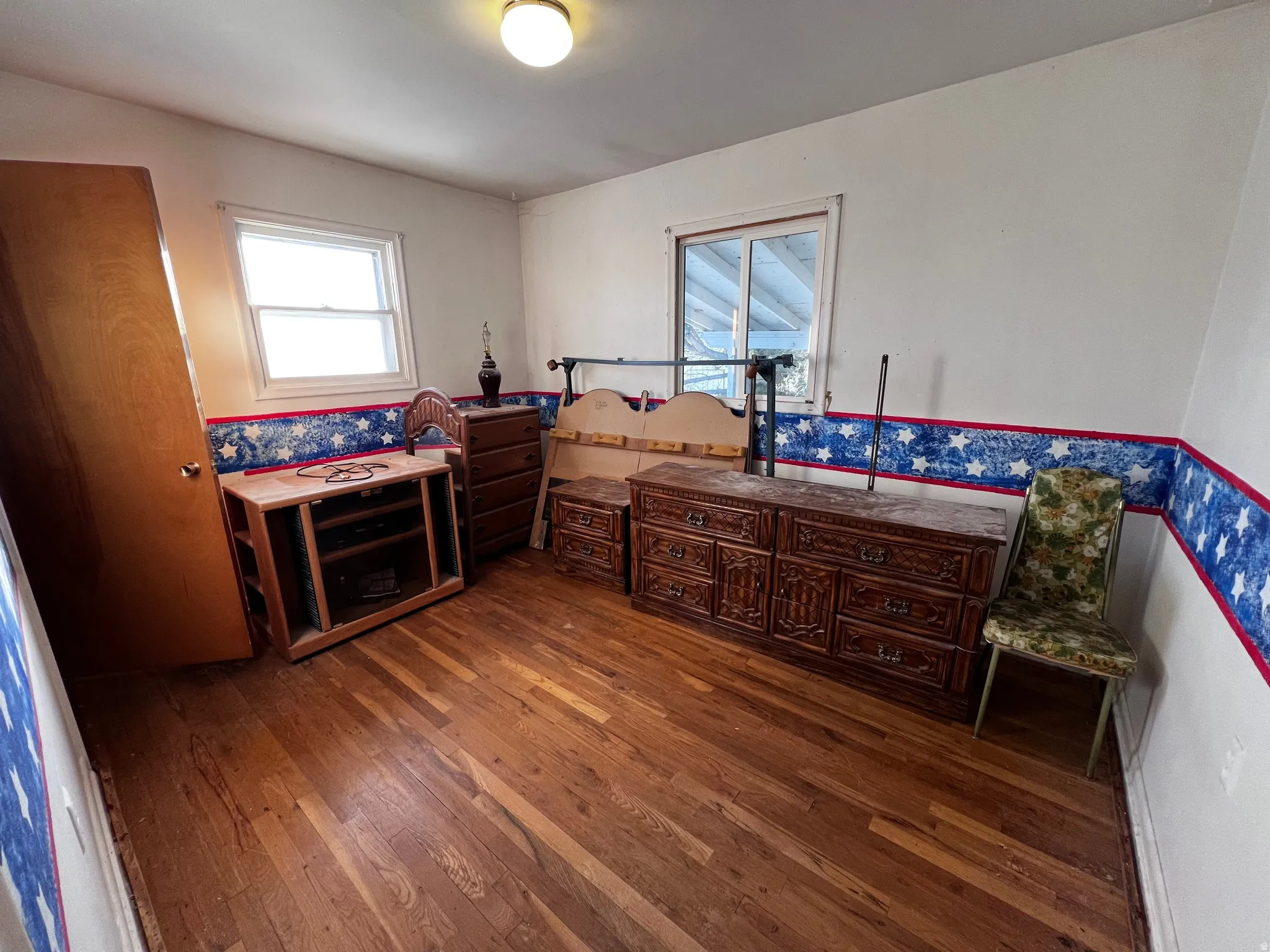 Bedroom featuring dark wood-style flooring