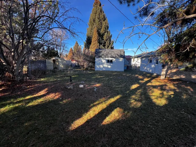View of yard with a storage unit