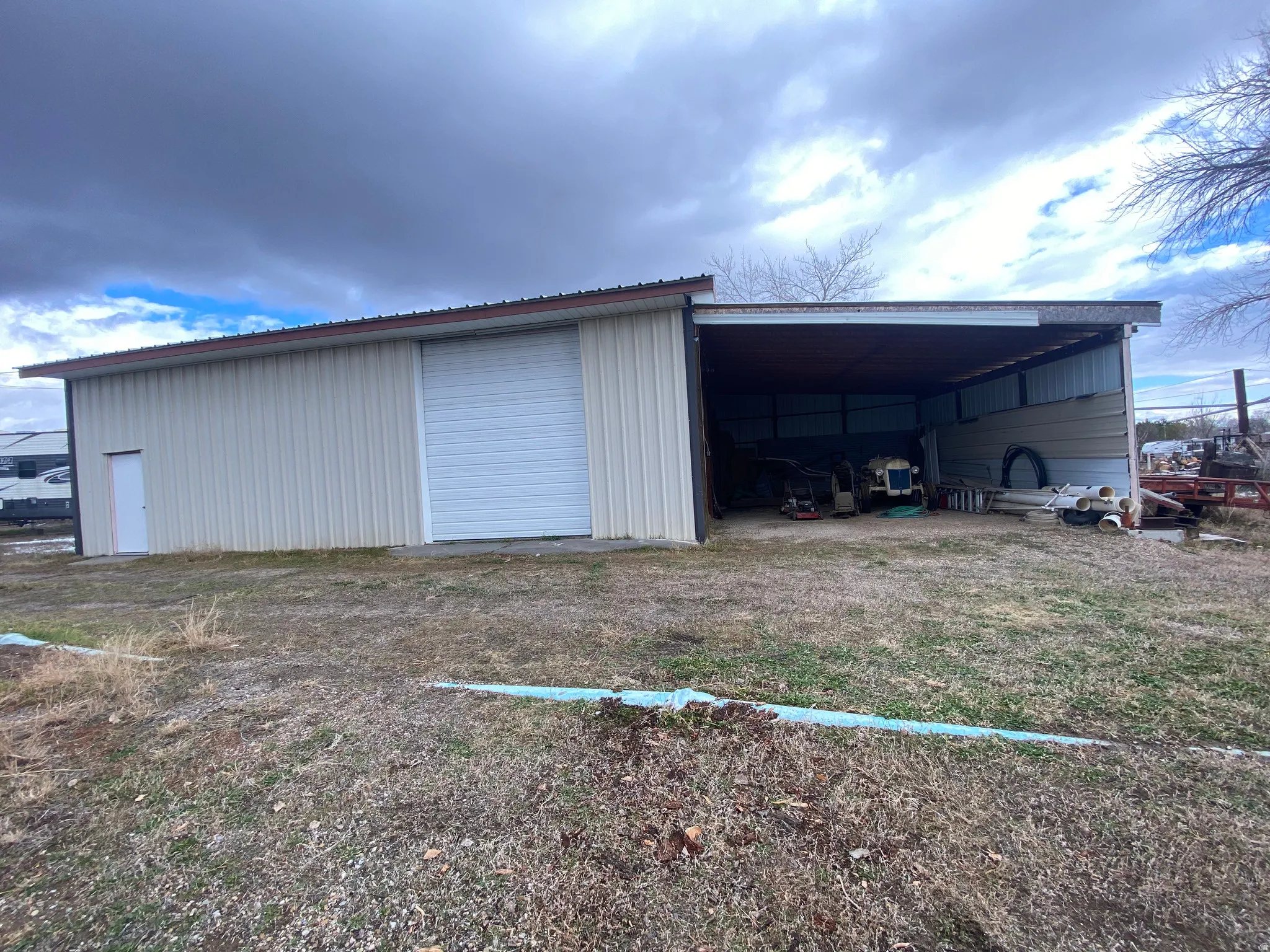 Side view of metal garage and shed