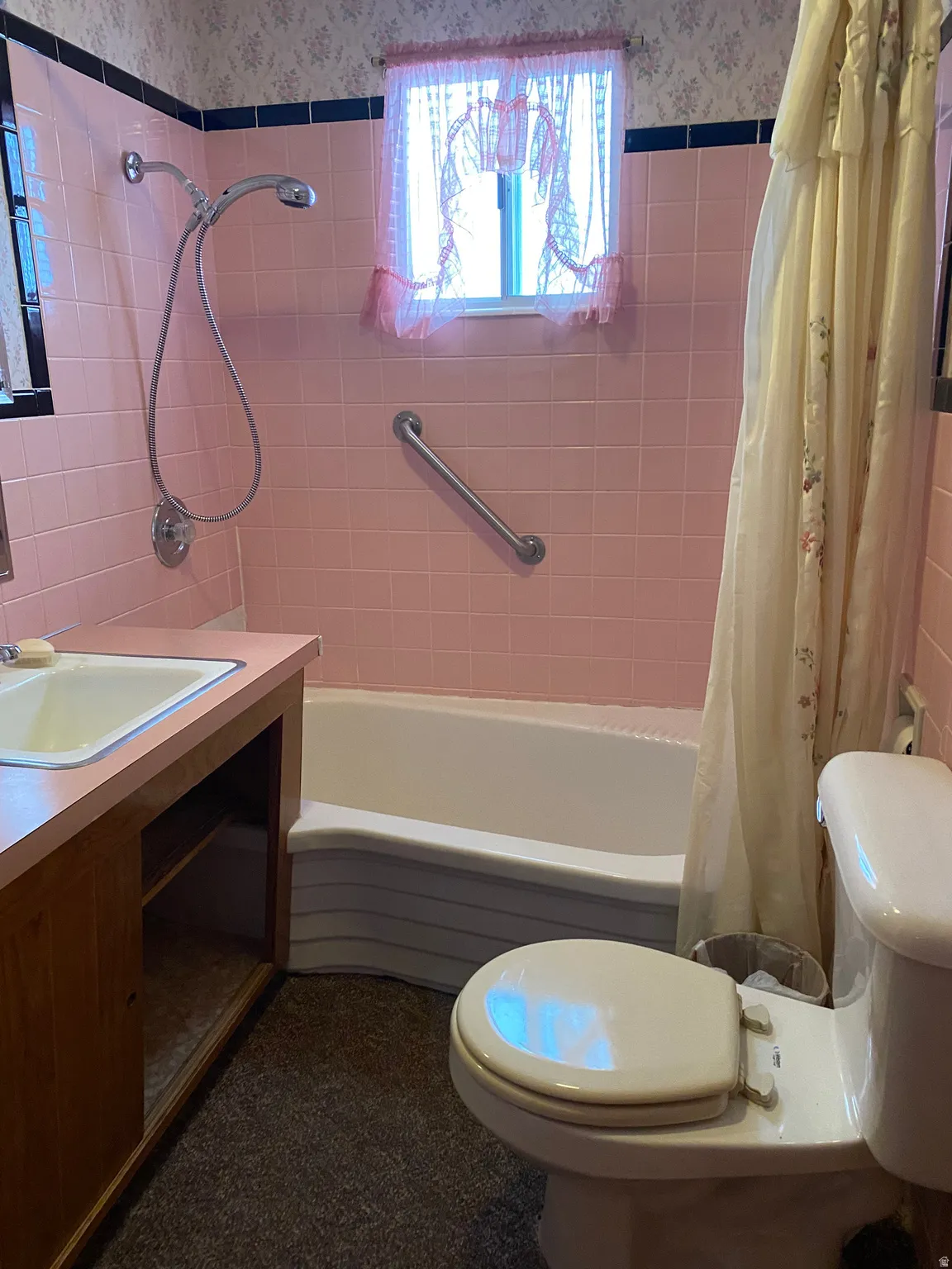 Full bath featuring shower / tub combo and vanity