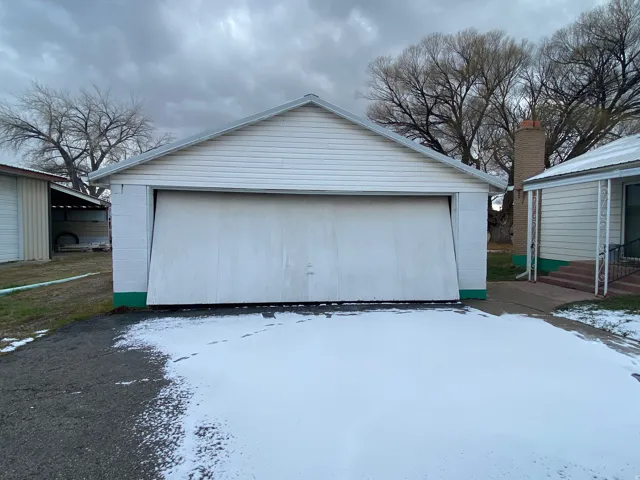 Block garage located at the bottom of the driveway