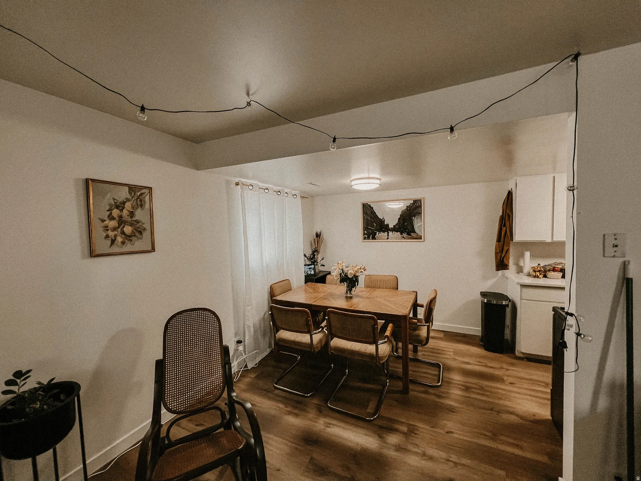 Dining area with dark wood-style floors and baseboards