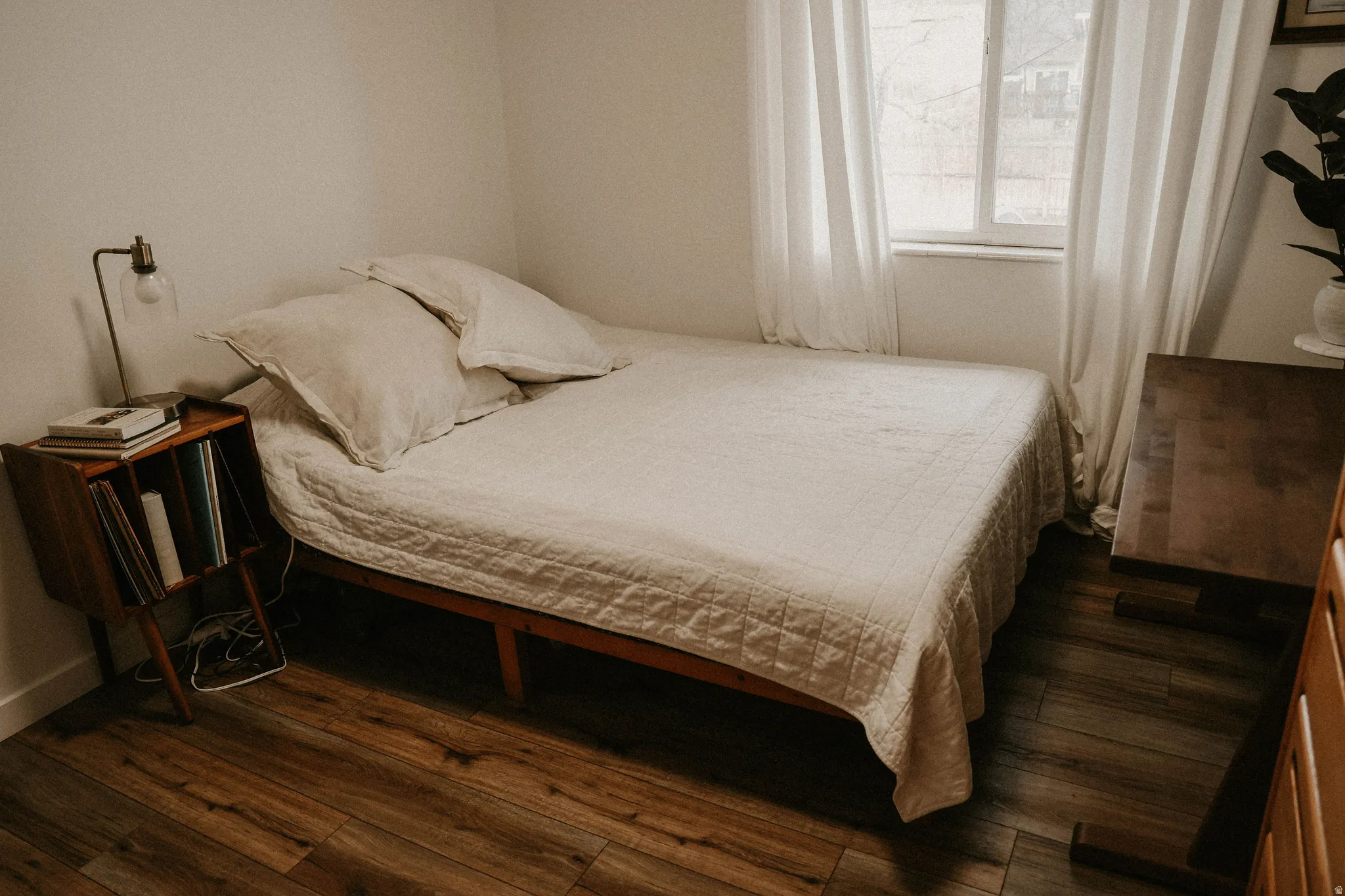 Bedroom with dark wood-style flooring