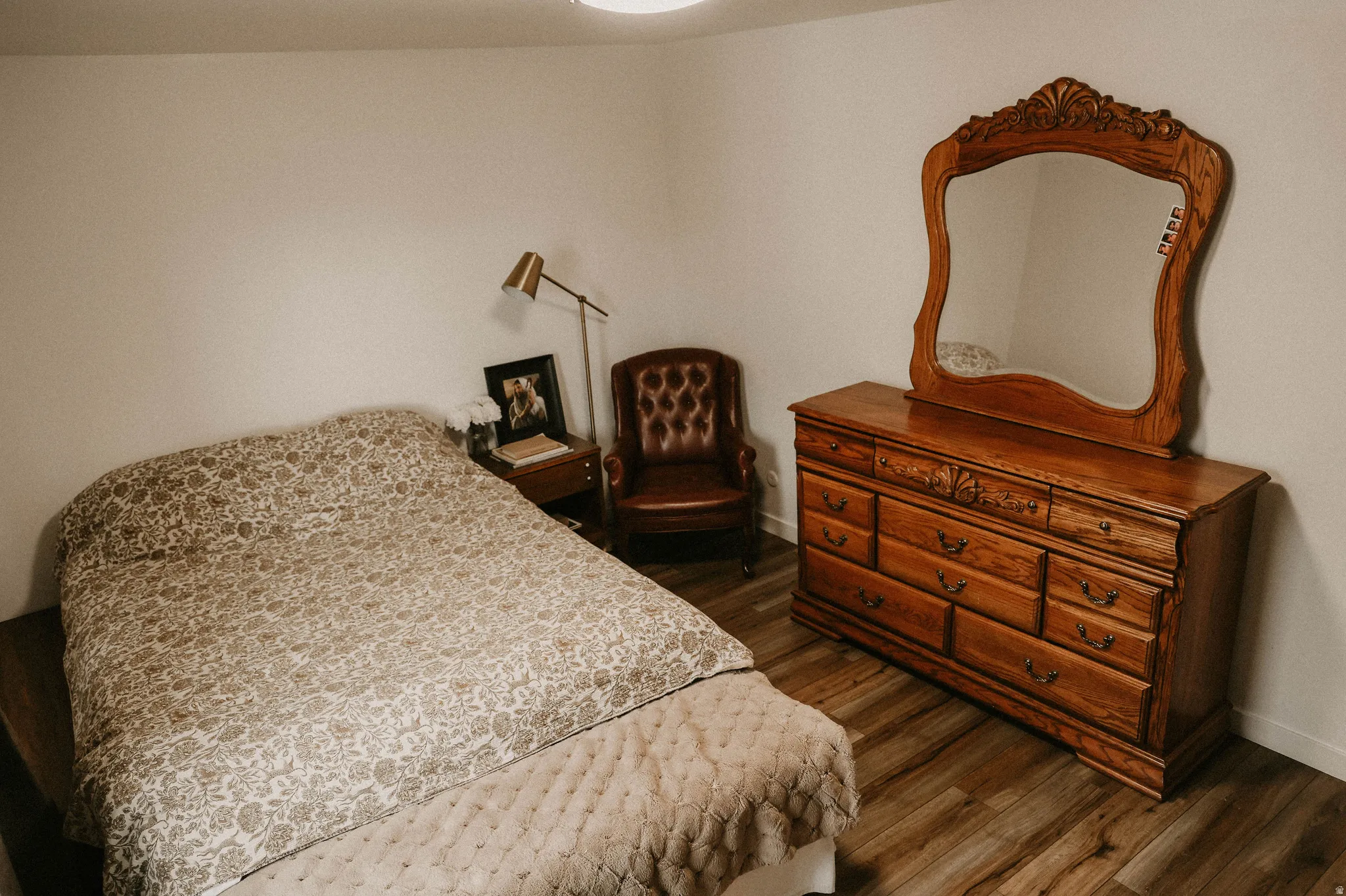 Bedroom featuring dark wood-style floors and baseboards