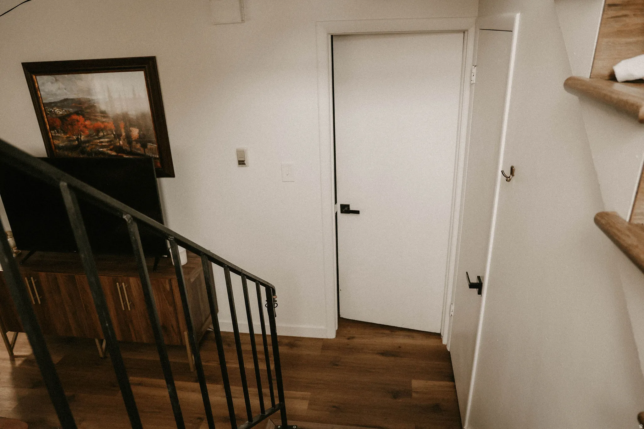 Stairway featuring wood finished floors