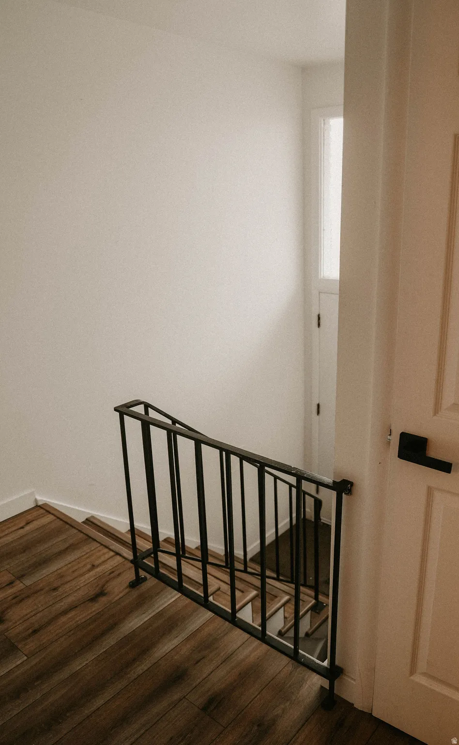 Stairway featuring wood finished floors and baseboards