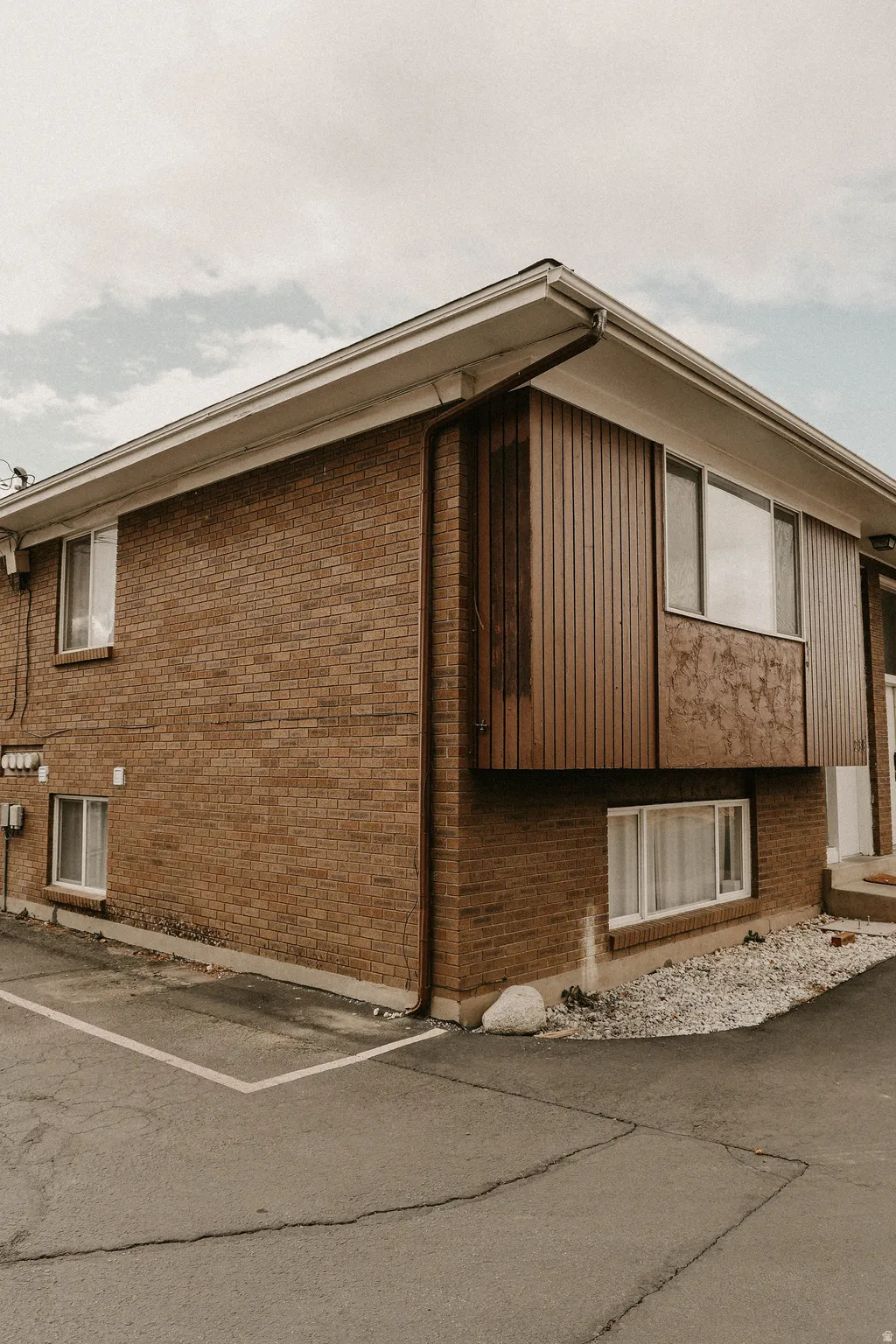 View of side of property featuring brick siding