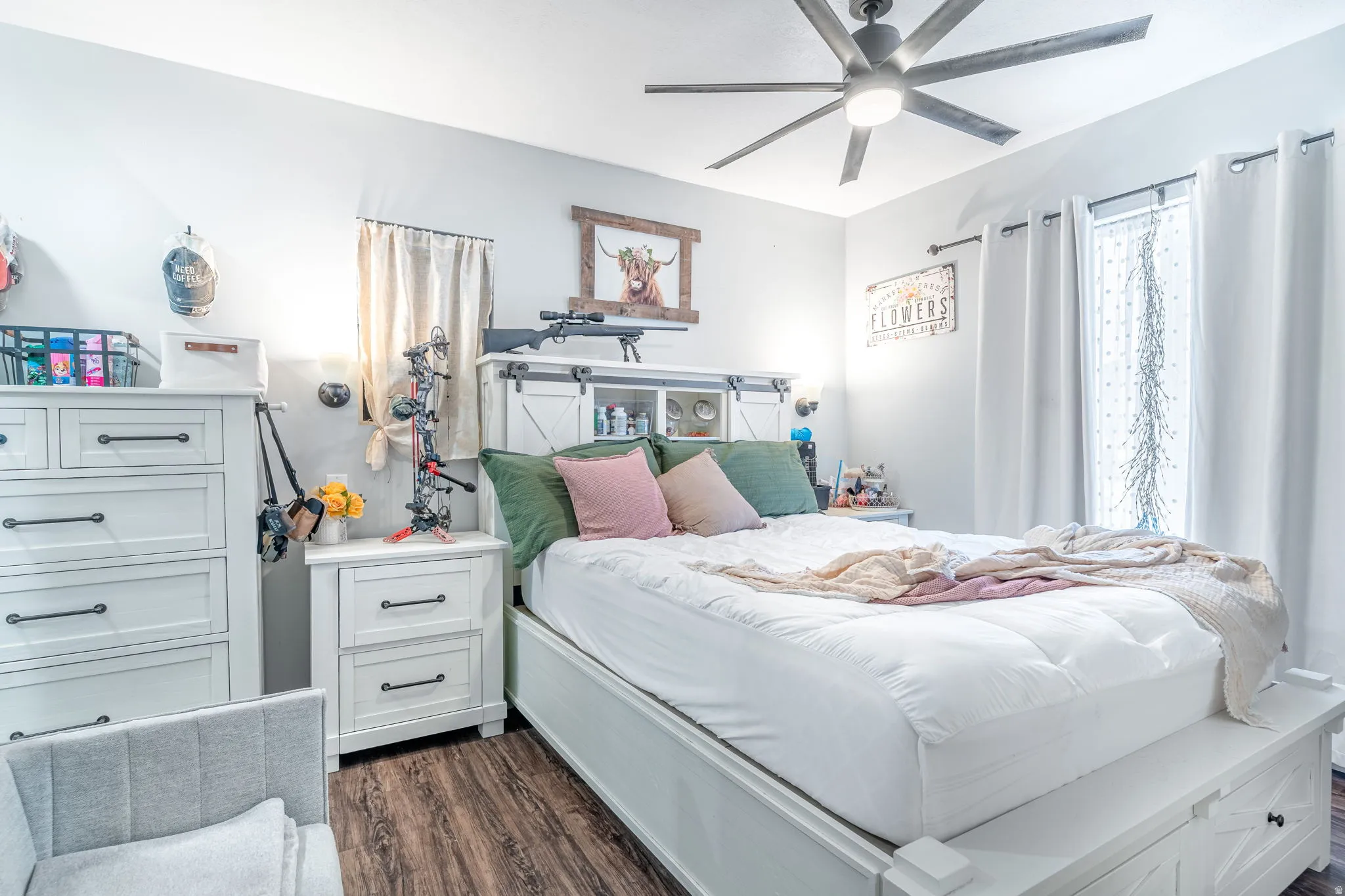 Bedroom with dark wood finished floors and a ceiling fan