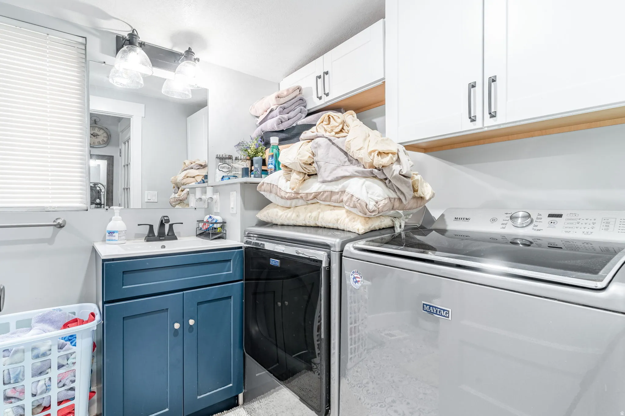 Laundry area with cabinet space and separate washer and dryer