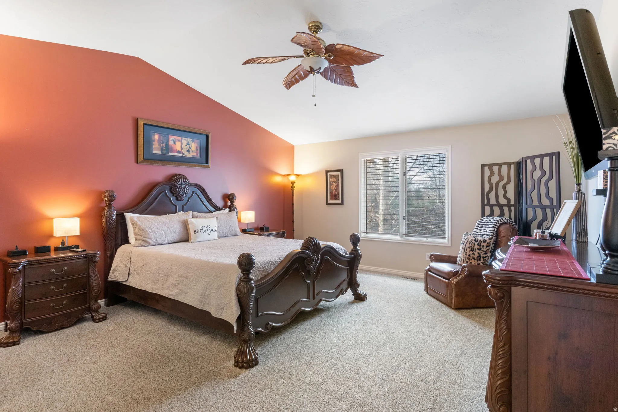 Bedroom featuring carpet flooring, lofted ceiling, and ceiling fan