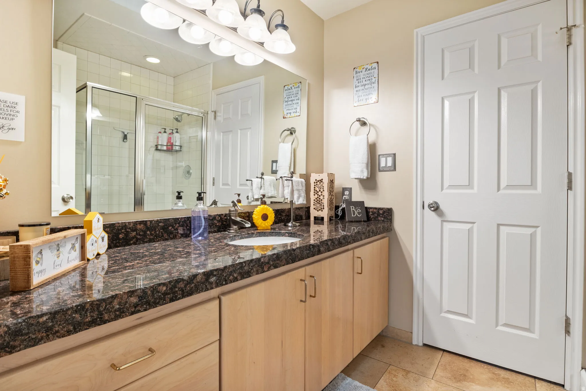 Full bathroom featuring vanity, a shower stall, and light tile patterned flooring
