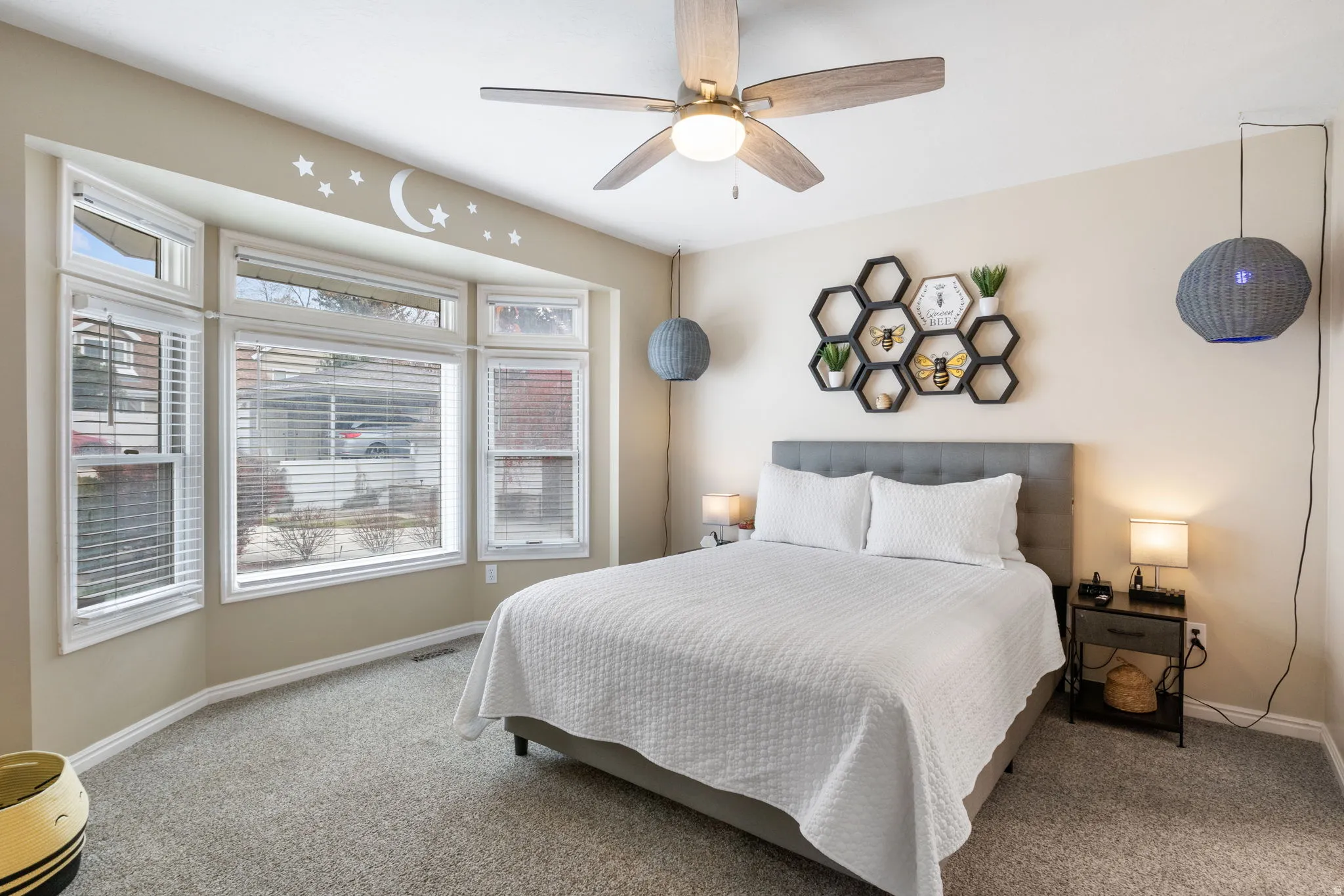 Carpeted bedroom with baseboards and ceiling fan