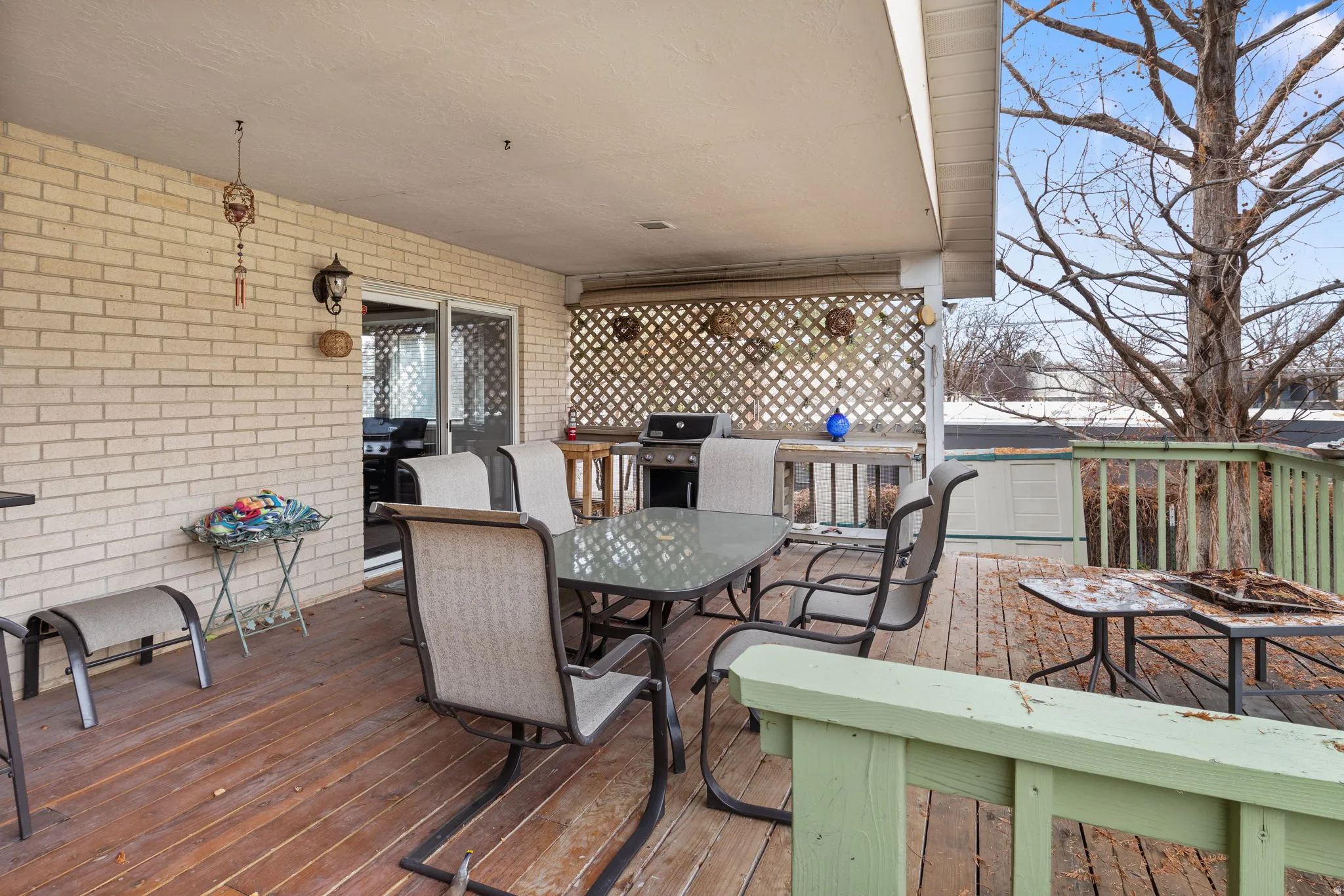 Wooden deck with outdoor dining space and grilling area