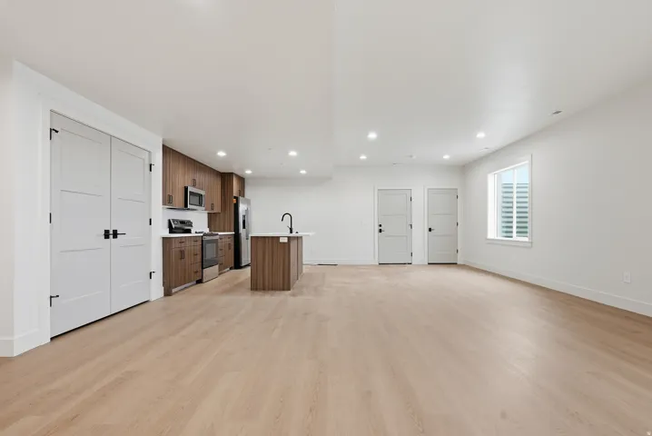 Unfurnished living room with light wood-style flooring and recessed lighting