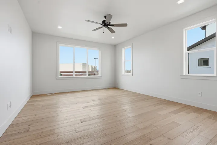 Spare room with a ceiling fan, recessed lighting, and light wood finished floors