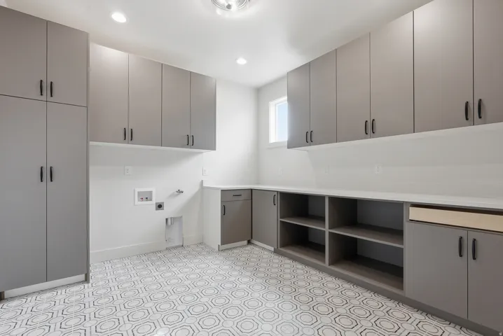 Laundry room with hookup for a gas dryer, washer hookup, recessed lighting, cabinet space, and hookup for an electric dryer