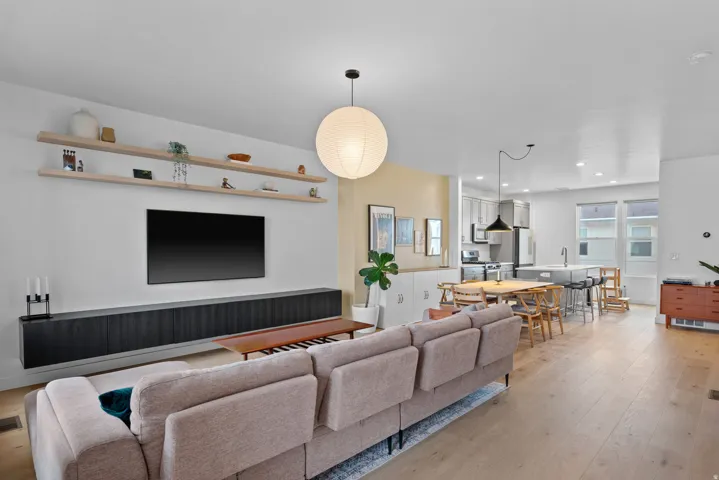 Living room with light wood finished floors and recessed lighting