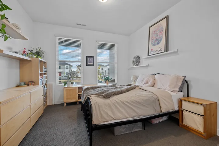 Bedroom featuring dark colored carpet