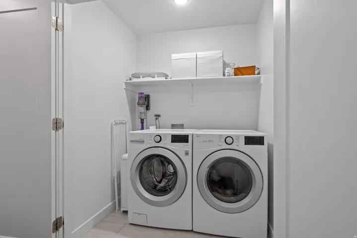 Laundry area with washing machine and dryer and baseboards