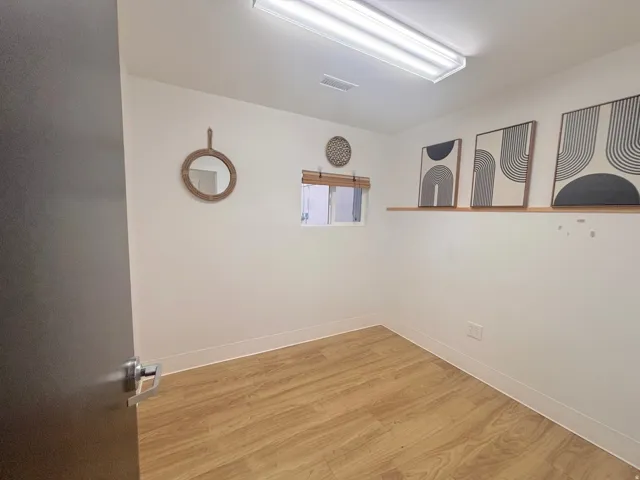 Unfurnished room with light wood finished floors and baseboards