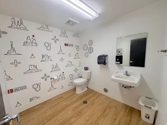 Half bath featuring light wood finished floors and toilet