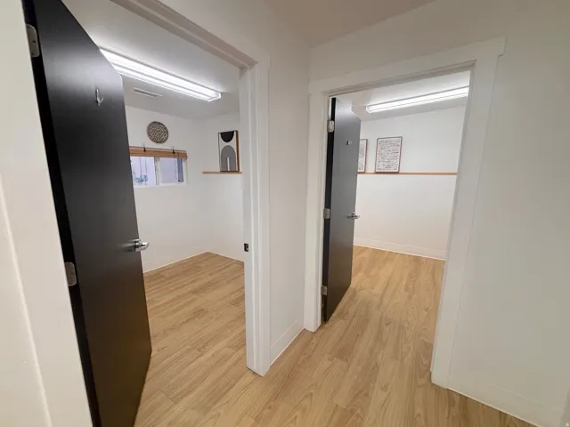 Corridor featuring light wood finished floors and baseboards