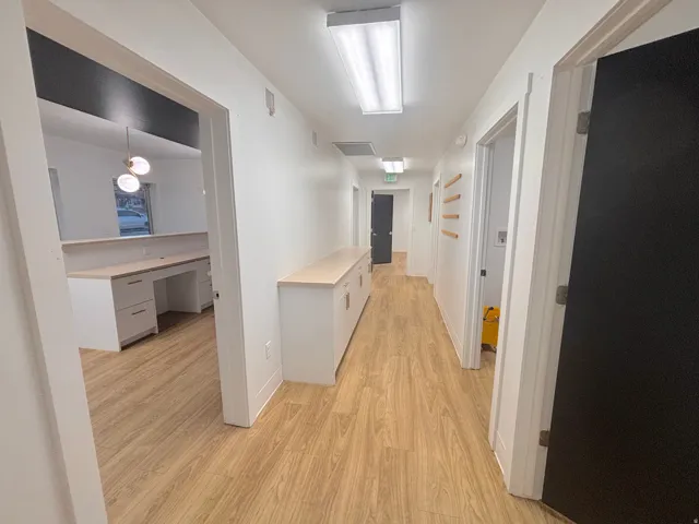 Hallway featuring an office area and light wood finished floors