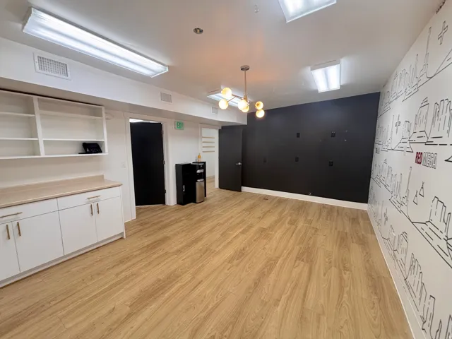 Kitchen with white cabinets, pendant lighting, light countertops, open shelves, and light wood finished floors