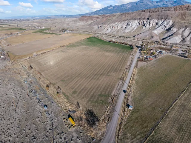 View of property location featuring rural landscape, a mountainous background, and large plots for crops